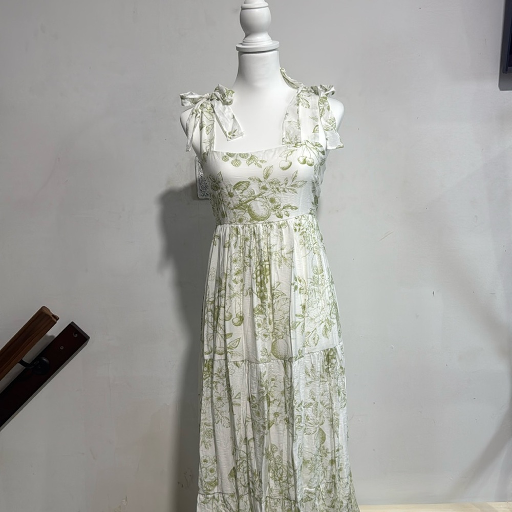 Green long dress with one bow on each side and prints of fruits